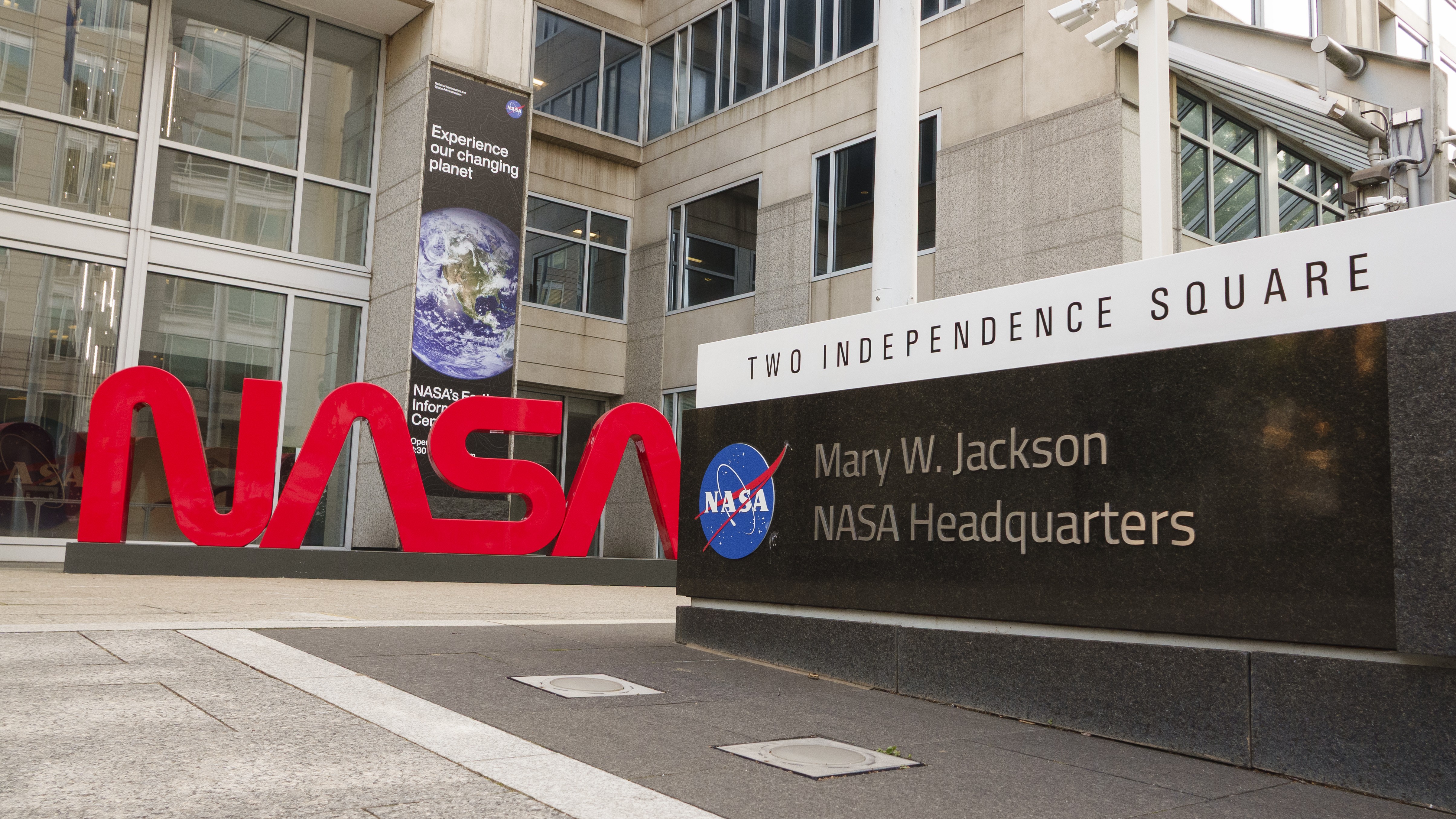 A NASA logo is displayed at the entrance to the Mary W. Jackson NASA Headquarters building on June 2, 2025 in Washington, DC.