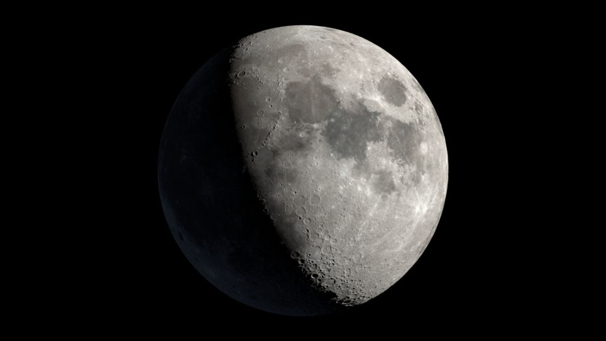 An image of the moon shown with over half its surface illuminated during its waxing gibbous phase.