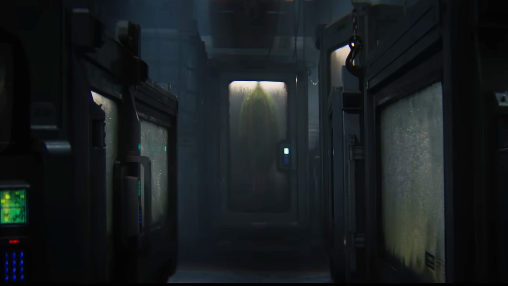 an egg-shaped mass can be seen inside a glass and metal case in a dimly lit room full of similar cases