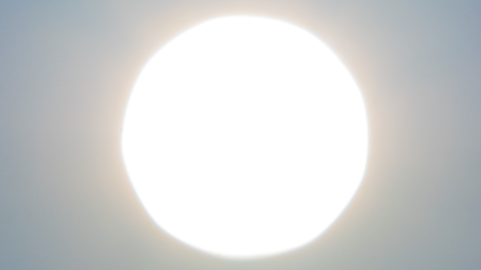 A round bright ball over a gray background