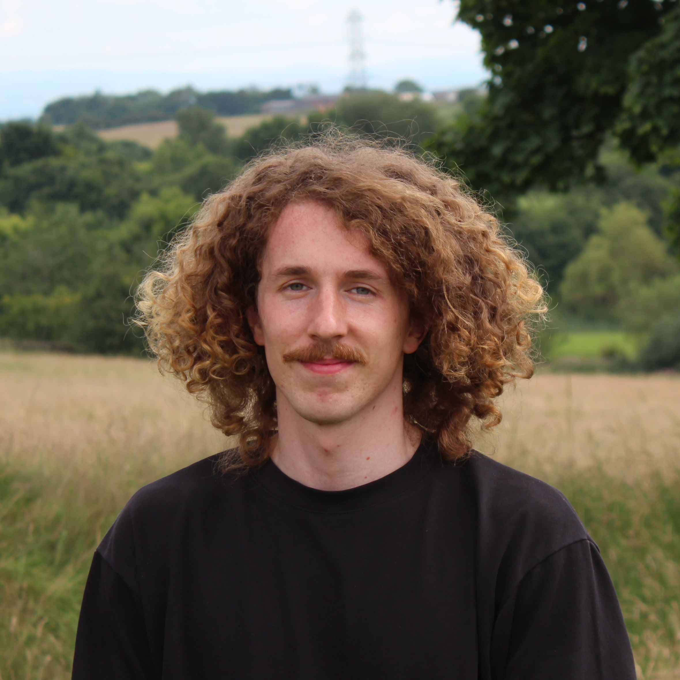 Portrait of author against the backdrop of a field.