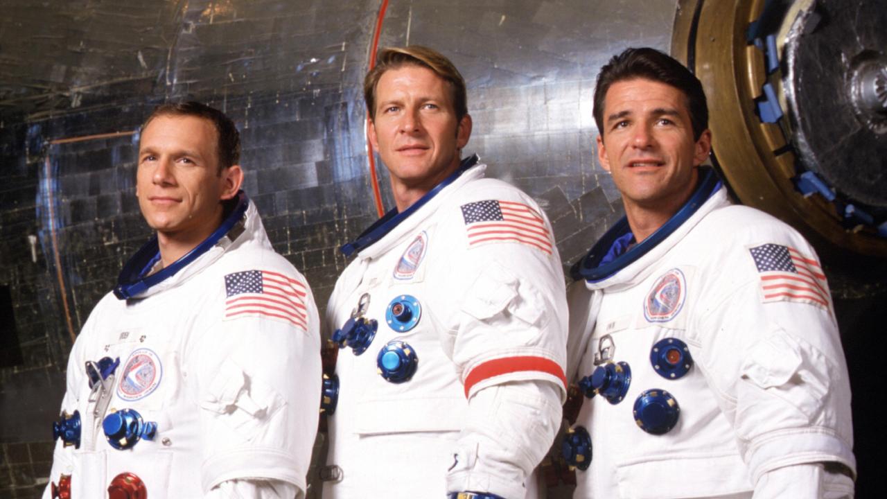 three astronauts in Apollo era spacesuits
