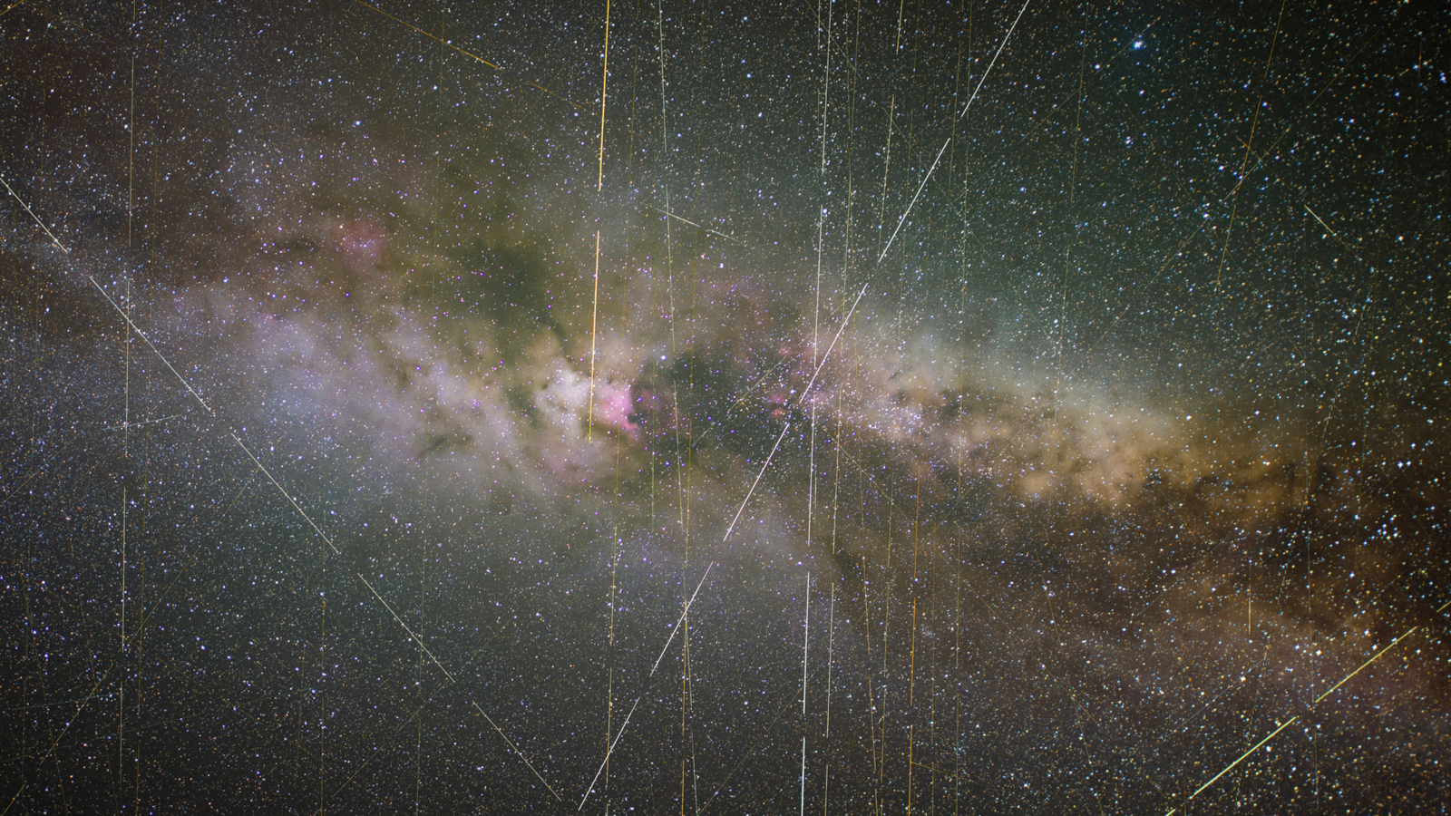 clouds of grey, white, and purple swirl over a black background