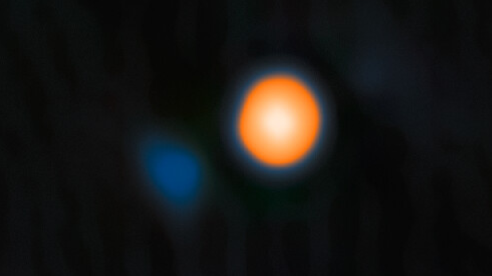 The glowing orange orb is Betelguese the faint blue smear. its companion stra seen for the first time by the ‘Alopeke instrument on the Gemini North telescope